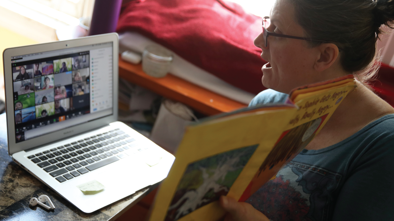 A first grade teacher in California conducts an online class from her living room.
