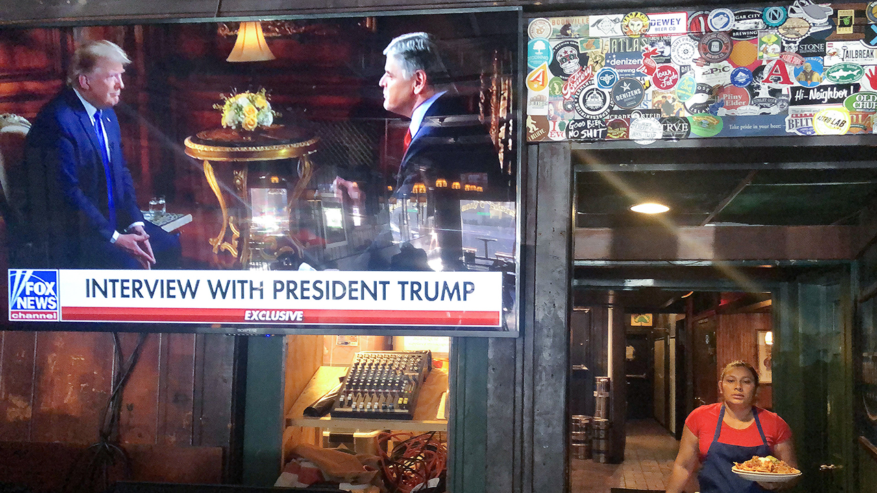 Fox News host Sean Hannity's pre-Super Bowl interview with President Trump shows at a Washington, D.C., bar on Feb. 2. (Mario Tama/Getty Images)