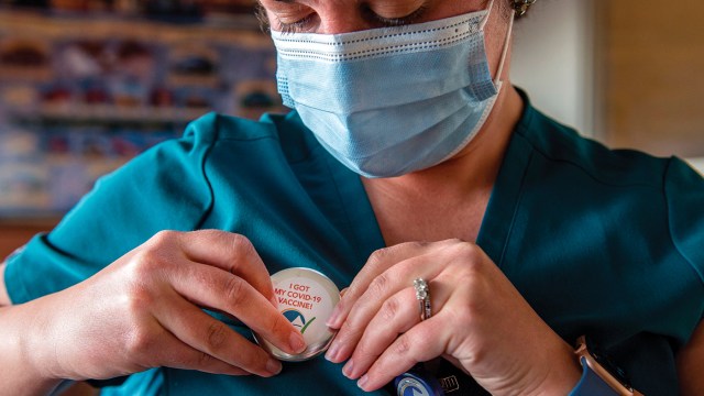 Nurse Caitlin Crowley pins on a button stating she has been vaccinated for COVID-19 at the East Boston Neighborhood Health Center in Boston on Dec. 24, 2020. (Joseph Prezioso/AFP via Getty Images)