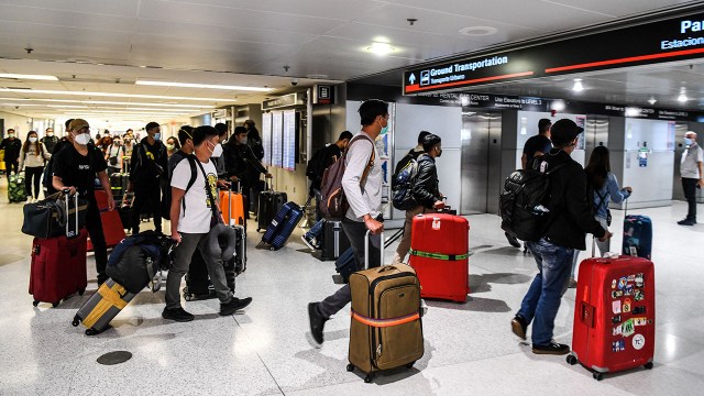 Travelers arrive at Miami International Airport ahead of Memorial Day weekend on May 26, 2021.