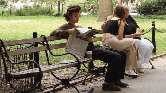 A newspaper reader in Washington Square Park on a September Sunday in New York City. (Gary Hershorn/Getty Images)