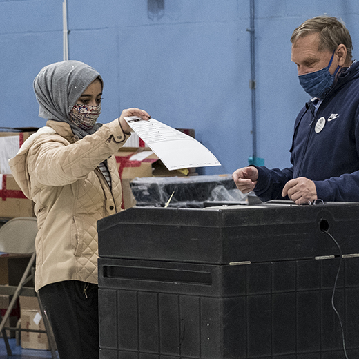 A first-time voter casts her ballot on Election Day in Manchester, New Hampshire. (Jodi Hilton/NurPhoto via Getty Images)