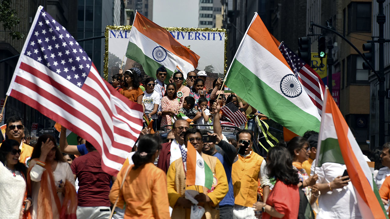 Participants wave U.S. and Indian flags along Madison Avenue in New York City during the annual India Day Parade in August 2019. (Anthony Behar/Sipa via AP Images)