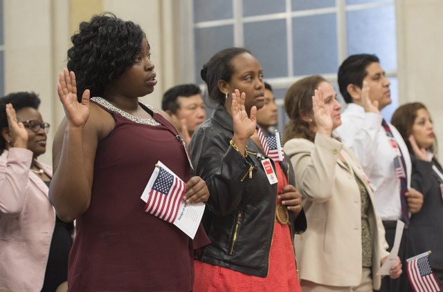 Candidates take the oath to become U.S. citizens during a naturalization ceremony at the Department of Justice in Washington, D.C., in 2016. (Saul Loeb/AFP via Getty Images)