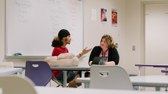 Photo of a senior at Building 21 High School in Allentown, Pennsylvania, talking with his social studies teacher about his senior presentation on May 23, 2024. (Michelle Gustafson for The Washington Post via Getty Images)