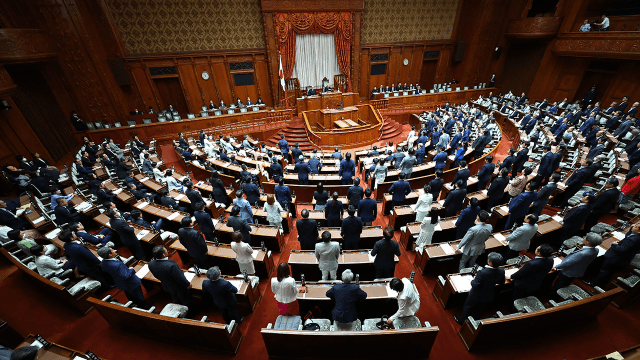 Members of Japan's Parliament approve a bill submitted by the ruling Liberal Democratic Party to revise the political funds control law on June 19, 2024. (STR/JIJI Press/AFP via Getty Images)