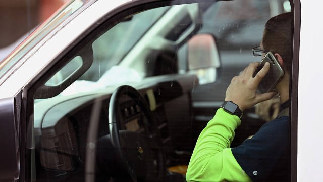 A driver talks on the phone while at a traffic light in Alexandria, Virginia. (Matt McClain/The Washington Post via Getty Images)