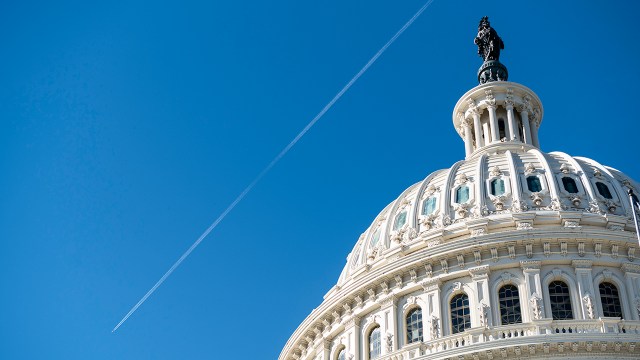 A jet leaves a contrail over the Capitol dome on Friday, Nov. 20, 2020. (Bill Clark/CQ-Roll Call via Getty Images)