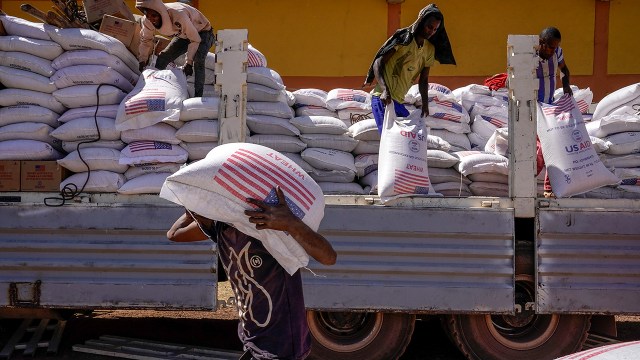 Volunteers at the Zanzalima Camp for Internally Displaced People unload an aid delivery from USAID in 2021 in Bahir Dar, Ethiopia. The Trump administration placed USAID staff around the world on administrative leave starting Feb. 7, 2025. (J. Countess/Getty Images)